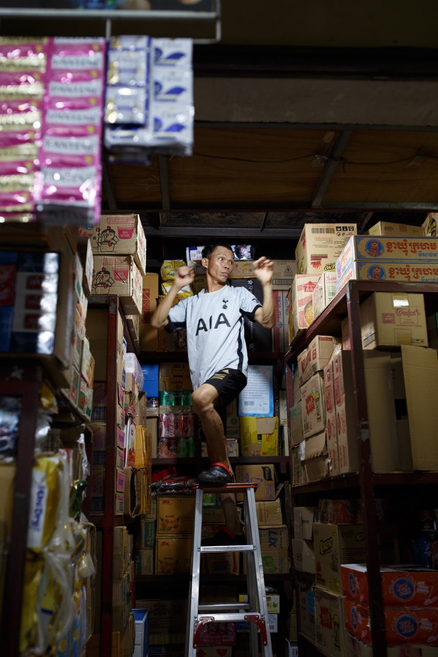 A Man Organizing the Storeroom